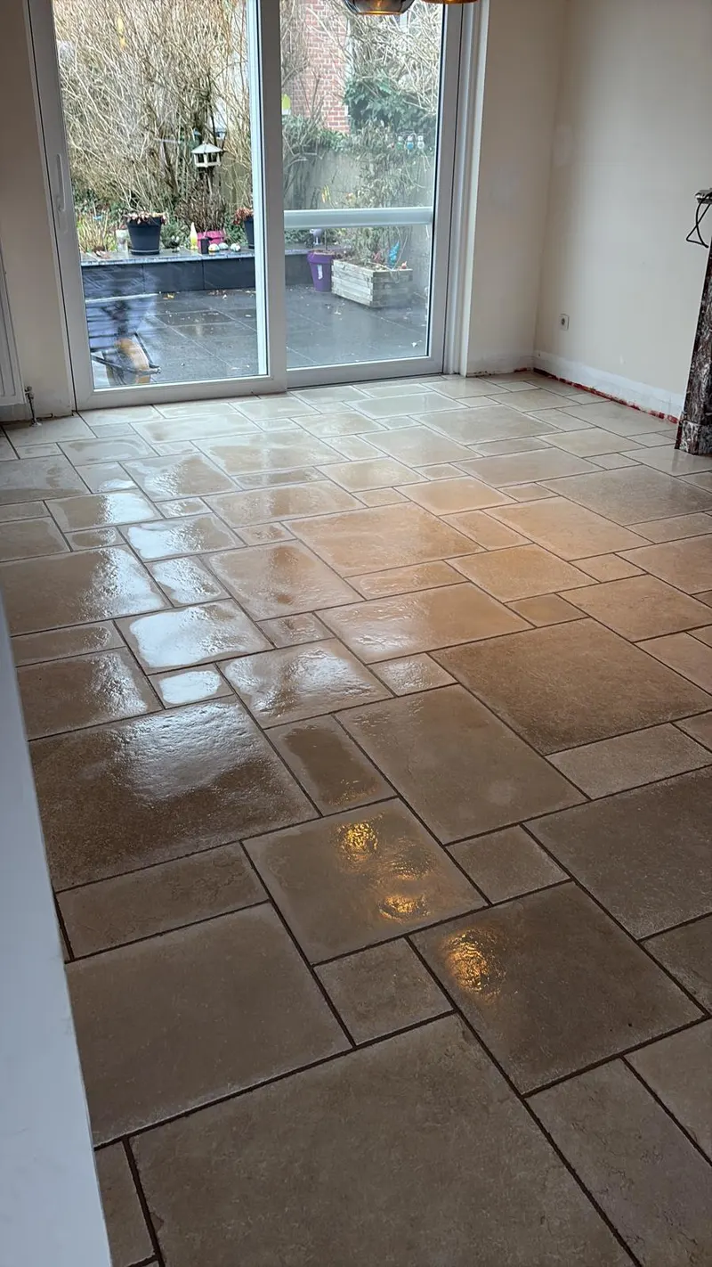 Living room floor in beige stone-effect tiles laid in a modular pattern